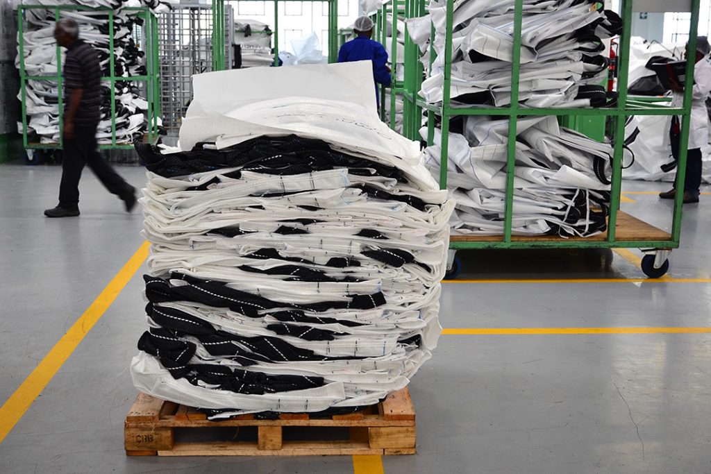 A stack of flattened bulk bags on a pallet shelf