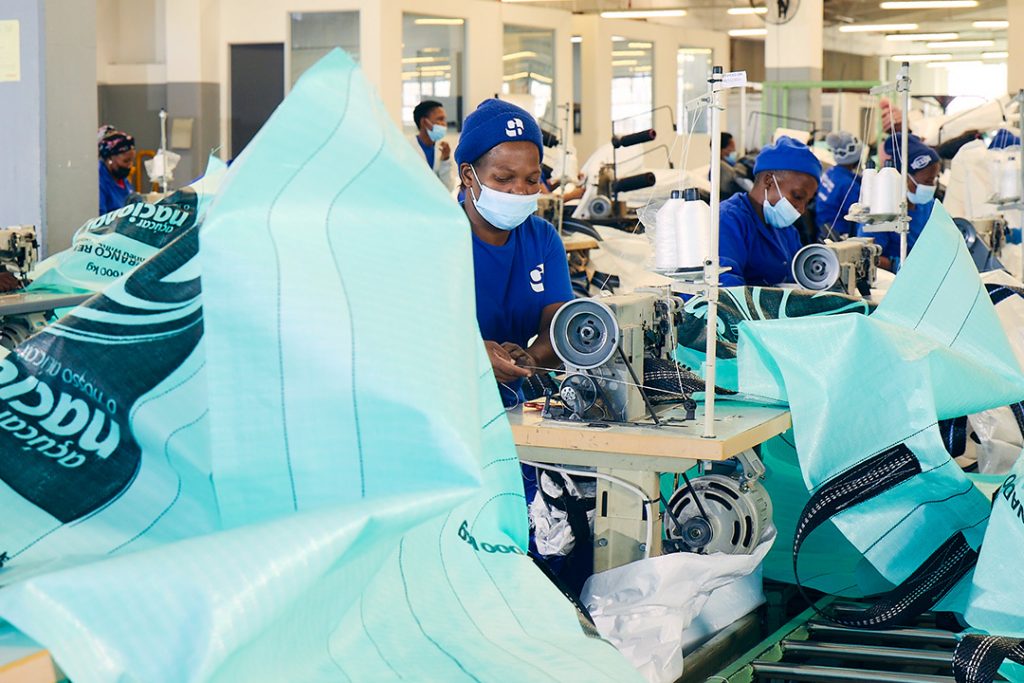 An employee at Custom Bulk Bags manufactures a FIBC for a customer