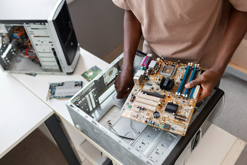 A man removes a circuit board from a mainframe computer.