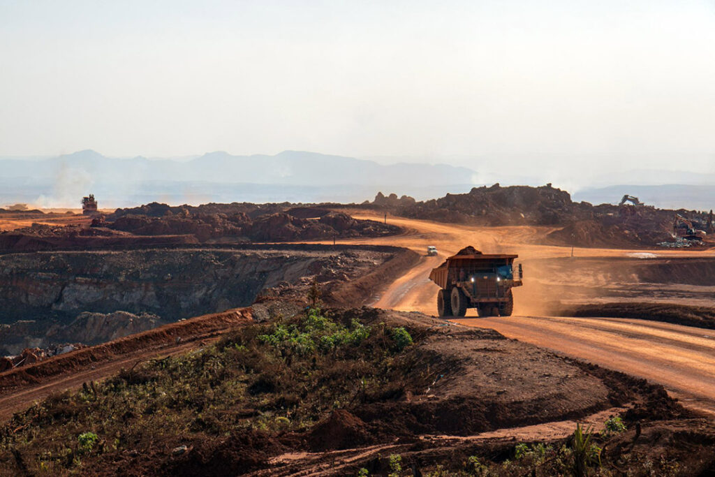 A dump truck driving on a dusty road on one of the mines in South Africa.