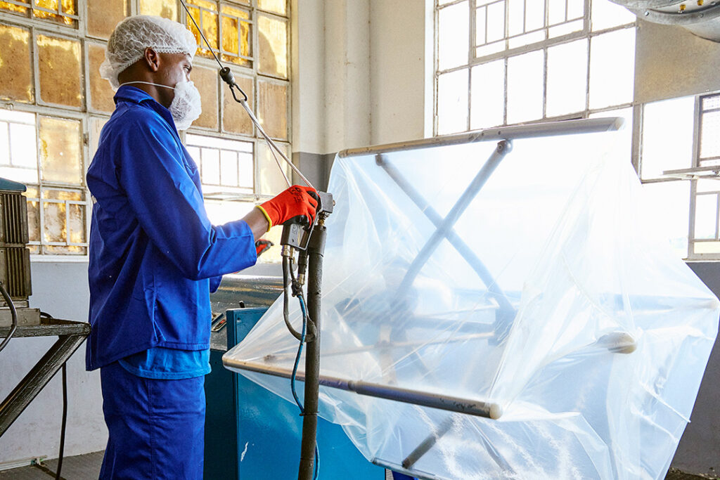 A worker at CBB prepares inner liners for their bulk bags