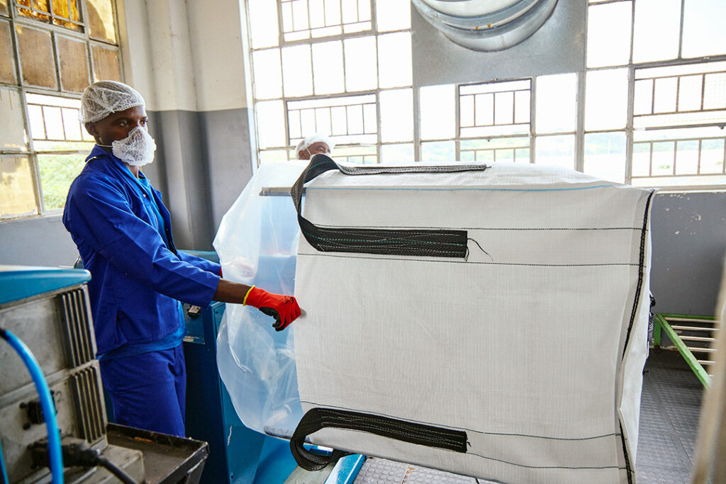 A worker at CBB prepares inner liners for their bulk bags