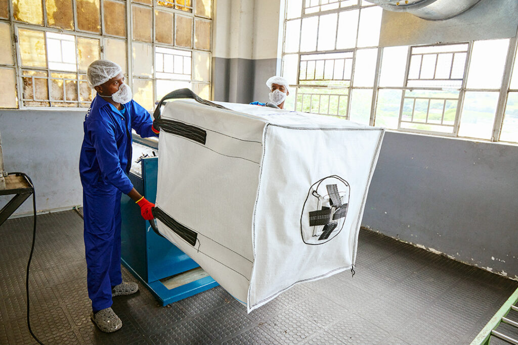 A worker at CBB prepares inner liners for their bulk bags
