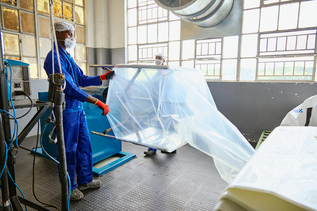 A worker at CBB prepares inner liners for their bulk bags
