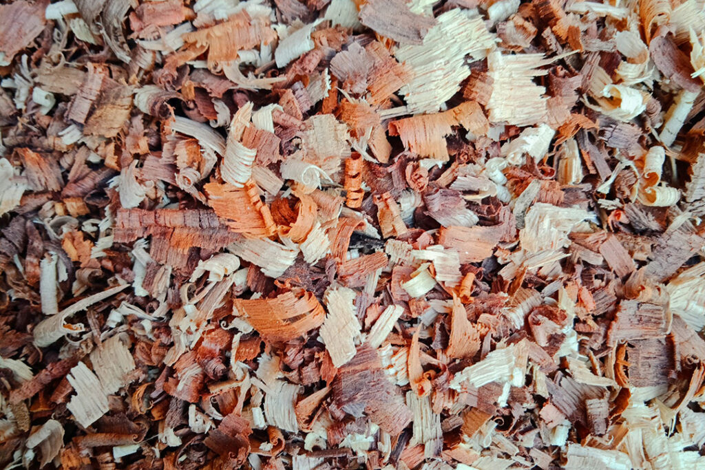 Brown wooden shavings used to create poultry bedding.