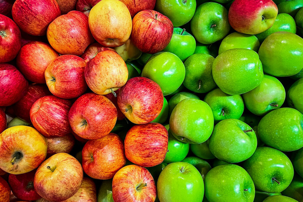 Red and green apples in a container